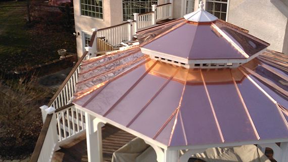 Copper roof gazebo in a home's backyard.