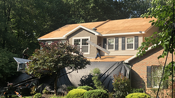 bare roof on home in Manheim PA with tarp covering front of house ready for roof to be replaced
