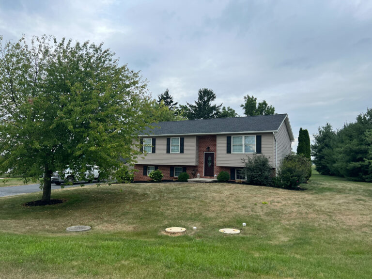red brick house with tan siding in Avon, PA
