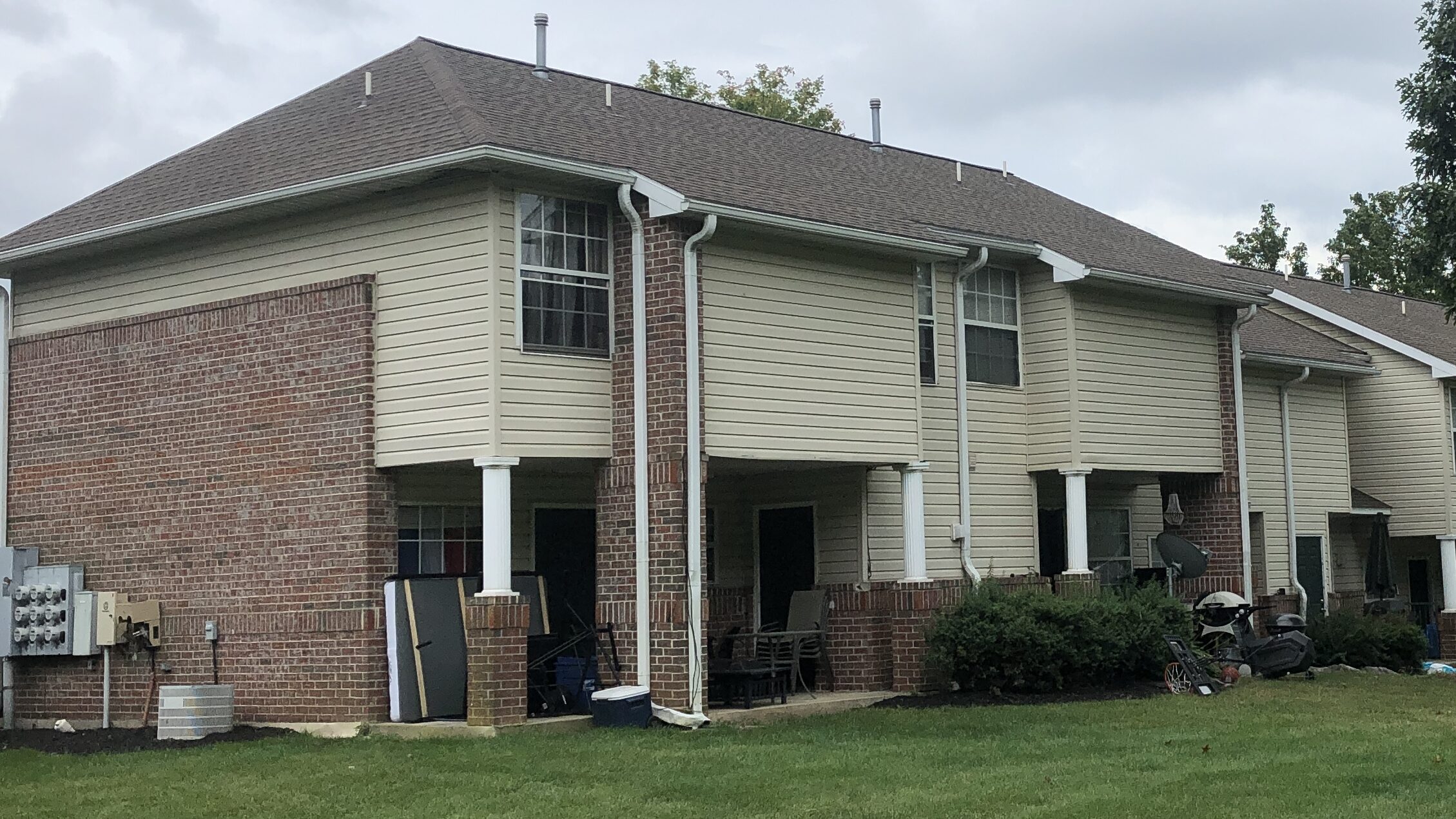 tan and red brick apartments done by commercial roofing contractor in Manheim PA